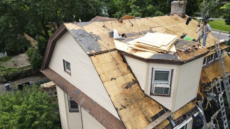 A house with a roof that is being repaired.