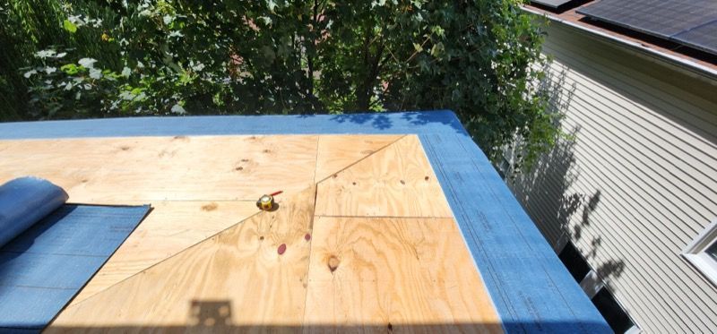 A wooden table is sitting on top of a blue table.