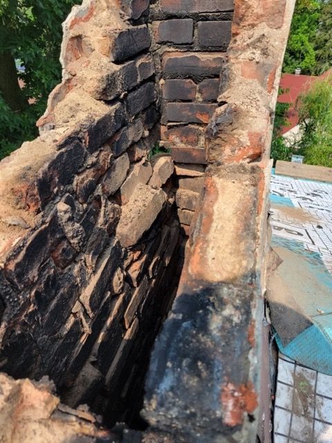 A close up of a brick wall with a hole in it