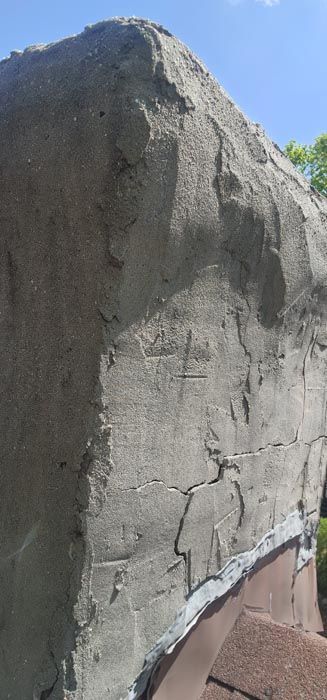 A close up of a rock with a blue sky in the background.