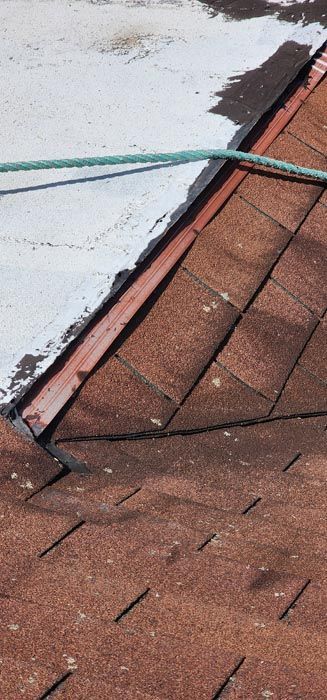 A close up of a roof with a hose attached to it.