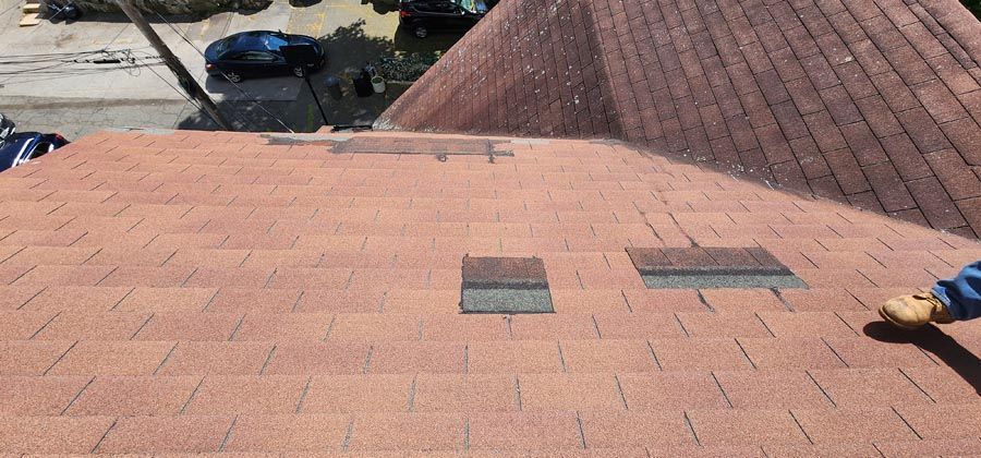 A person is working on the roof of a house.