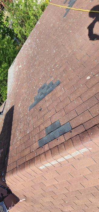 A close up of a roof with a lot of shingles on it.