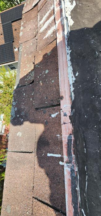 A close up of a roof with a shadow on it.