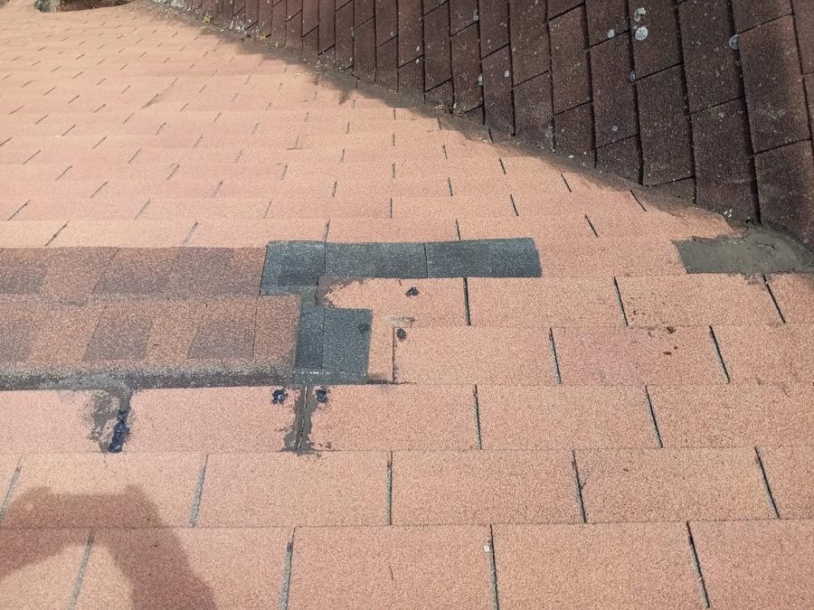 A brick walkway with a shadow of a person on it.