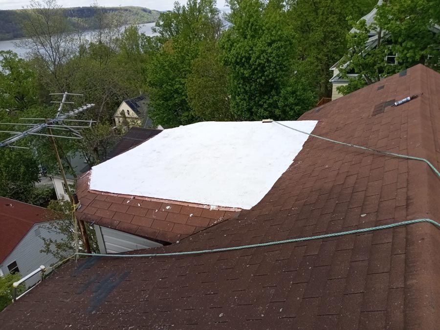 A brown roof with a white sheet on top of it