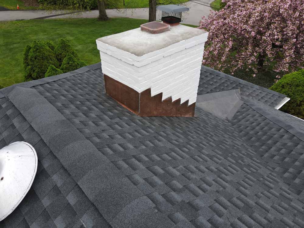 A chimney is sitting on top of a roof.