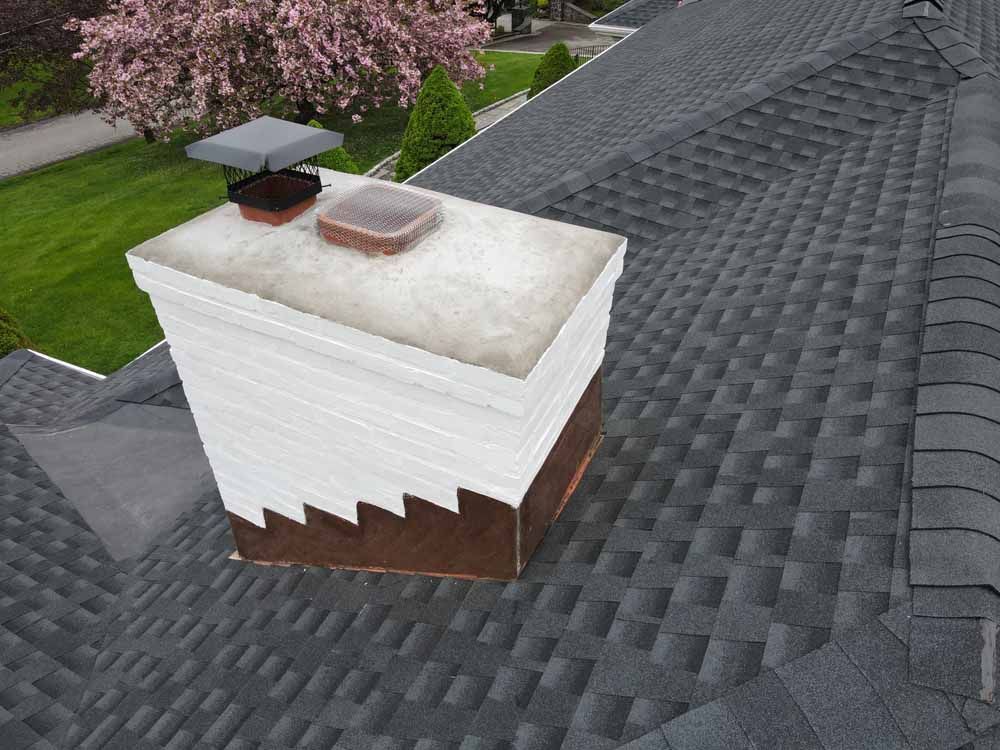 An aerial view of a chimney on top of a roof.