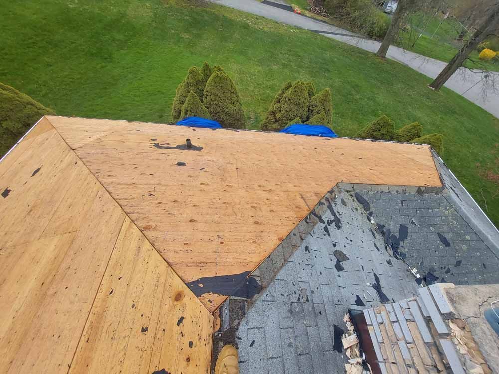 An aerial view of a roof that is being repaired.