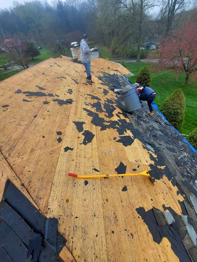 A man is working on the roof of a house.