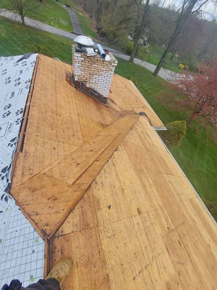 A wooden roof with a chimney on top of it.