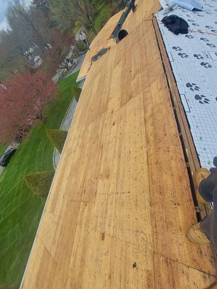 A person is working on a wooden roof.