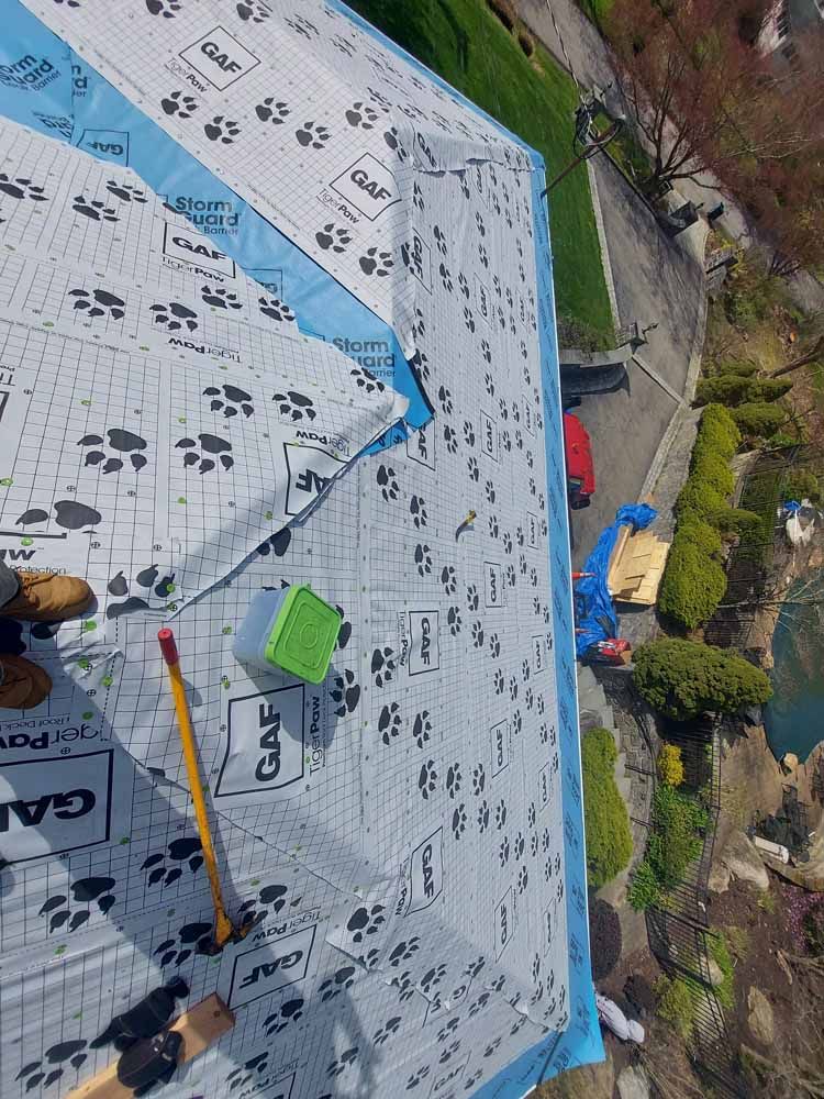 An aerial view of a person working on a roof.