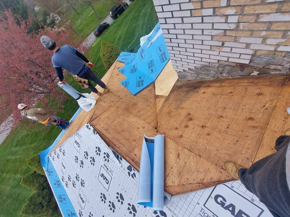 A group of men are working on a roof.