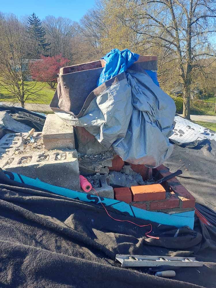 A pile of bricks is sitting on top of a roof.