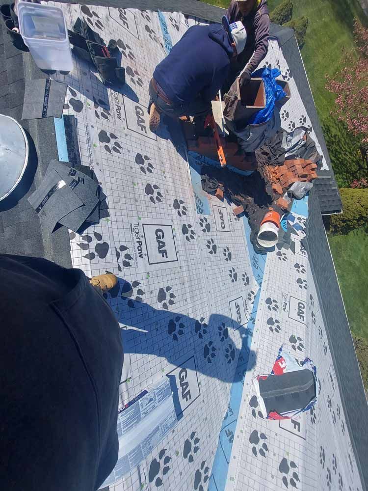 A group of people are working on a roof.