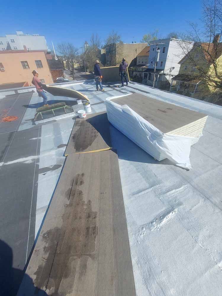 A group of people are working on a roof.