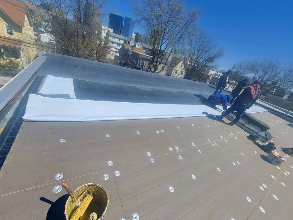 A group of people are working on a roof.