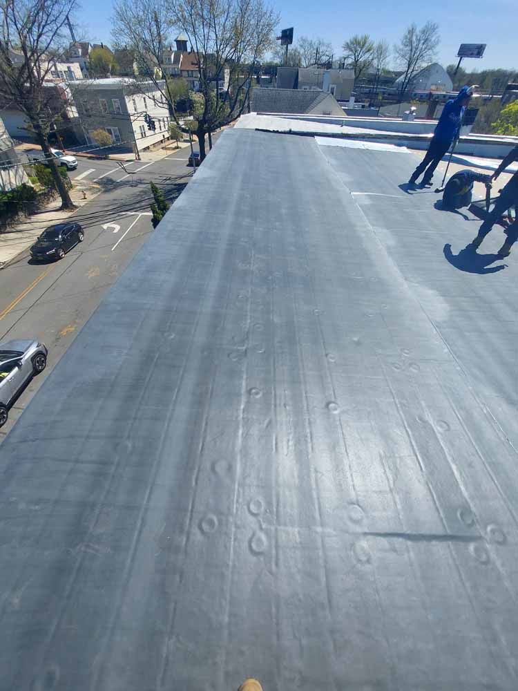 A group of people are standing on top of a roof.