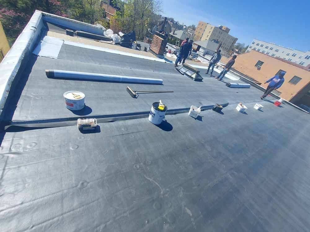 A group of people are working on the roof of a building.