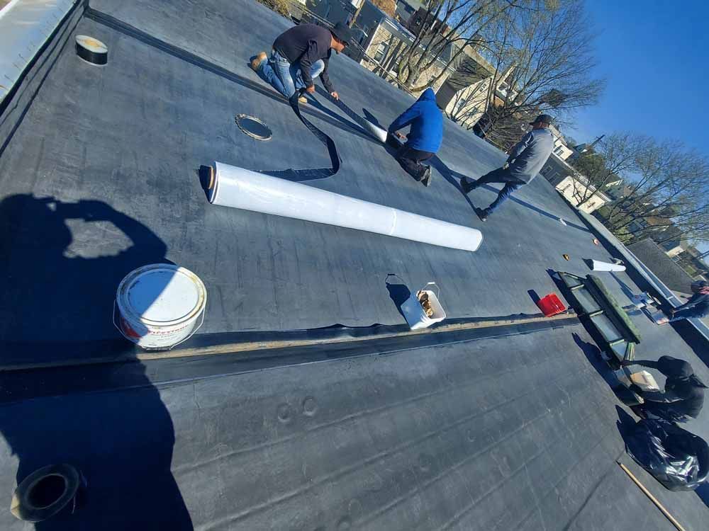 A group of people are working on a roof.