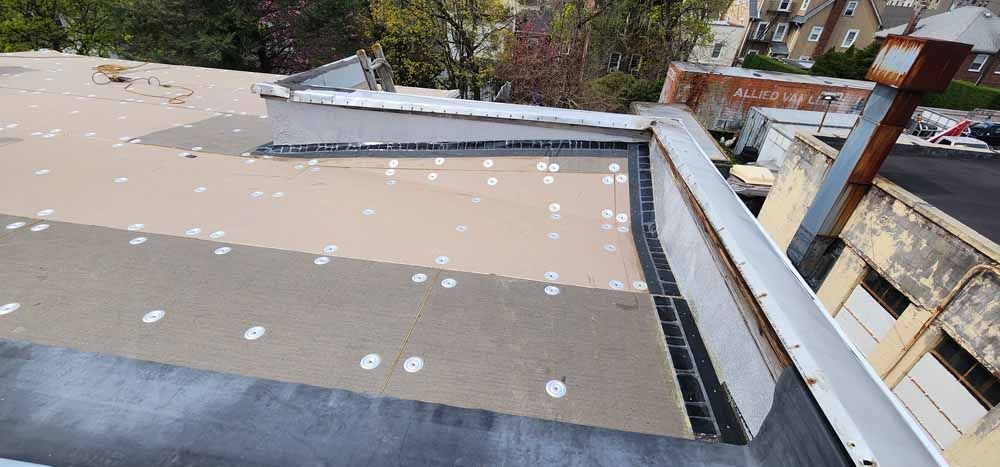 A view of a roof from a balcony of a building.