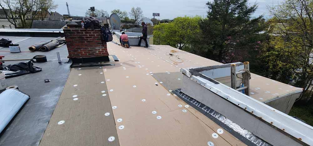 A group of people are working on a roof.