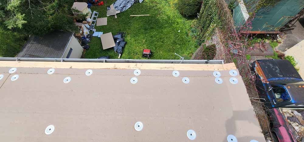 An aerial view of a roof being built in a backyard.