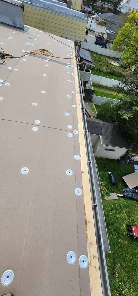 An aerial view of a roof with a gutter being installed.