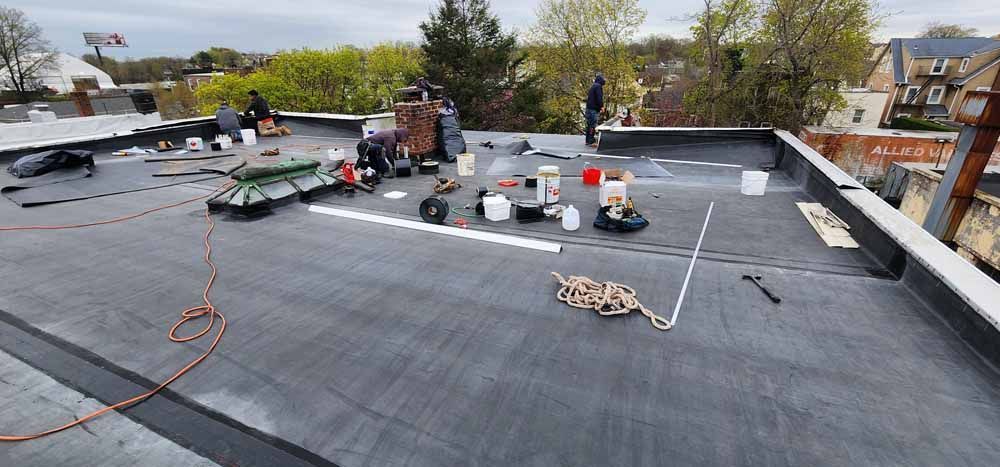 A group of people are working on a roof.