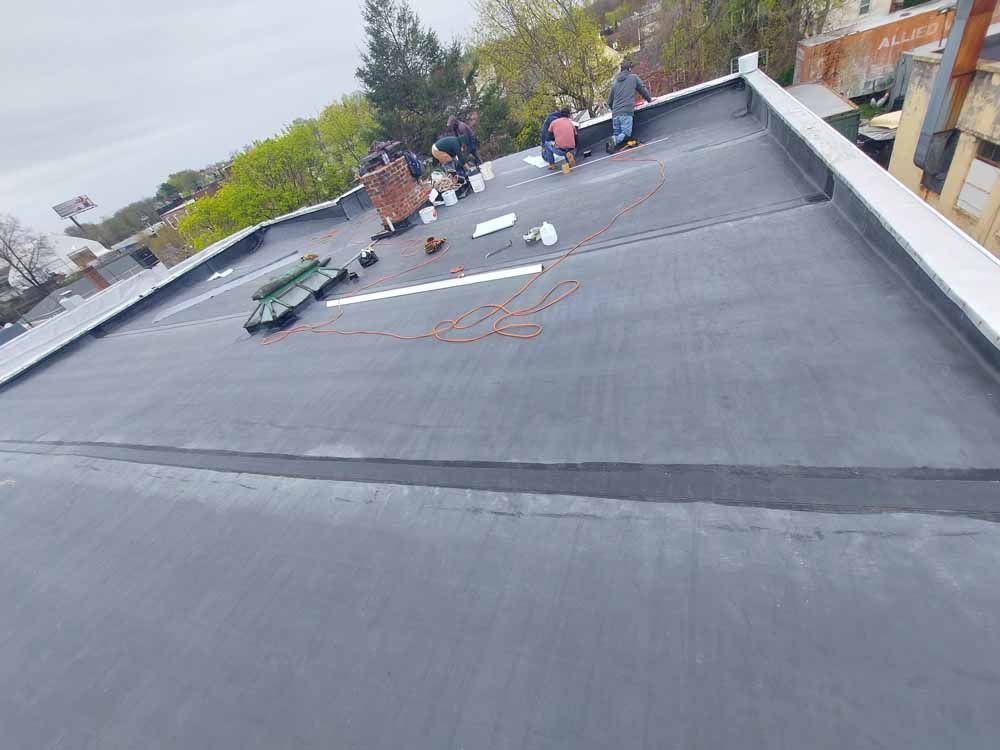 A group of people are working on a roof.