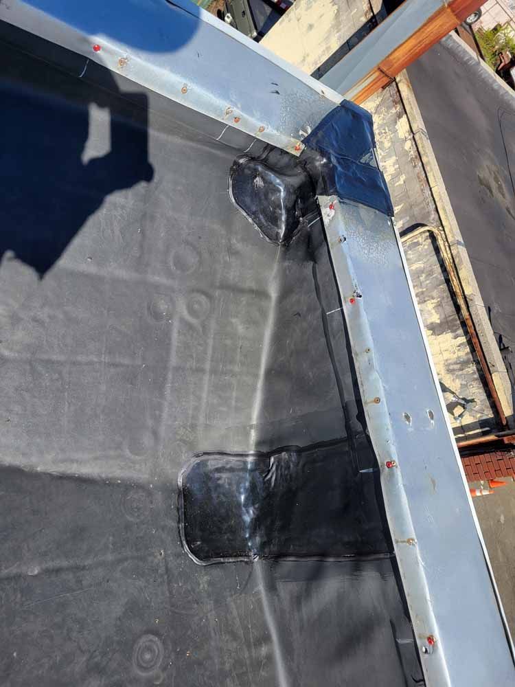 A close up of a roof with a shadow on it.