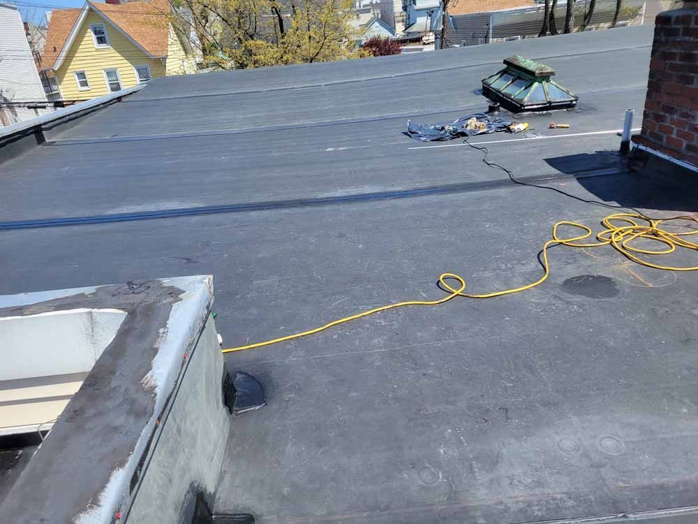 A black roof with a yellow cord hanging from it.