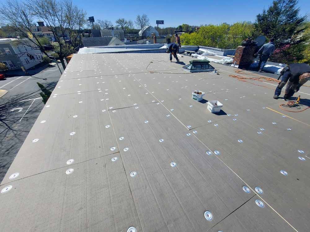 A group of people are working on a roof.