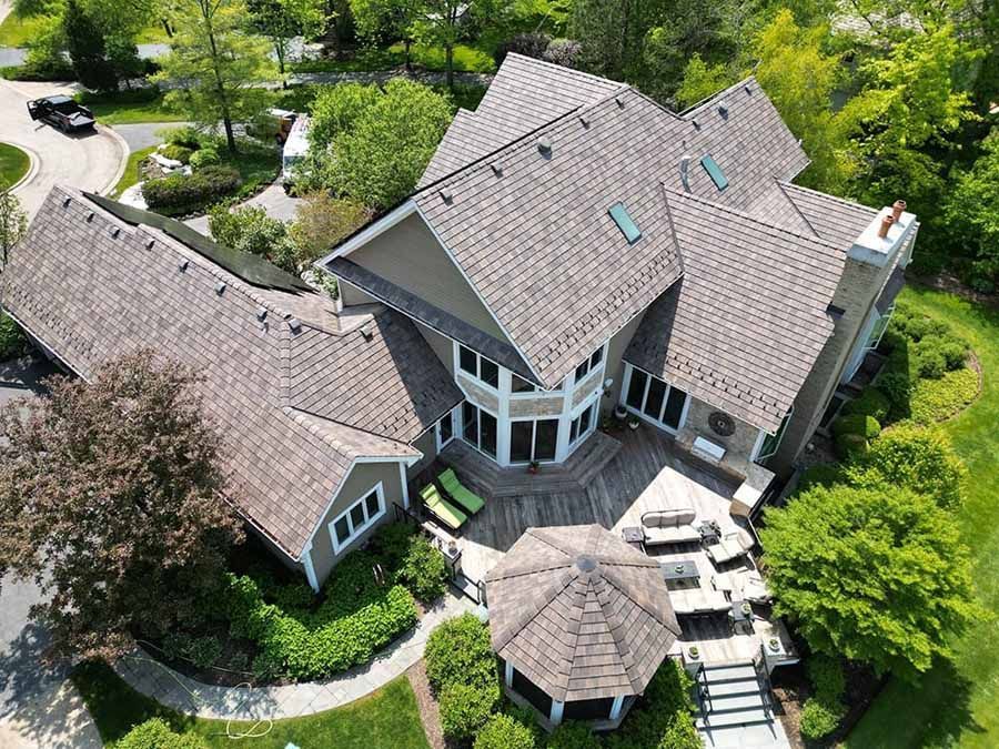 An aerial view of a large house with a gazebo in the backyard.