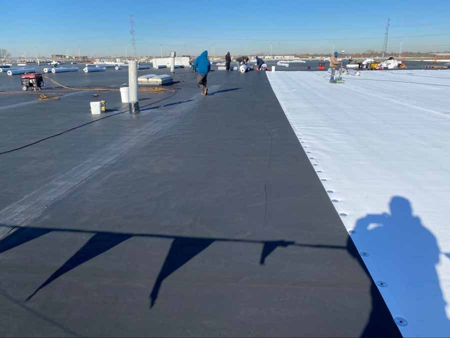 A group of people are standing on top of a roof.