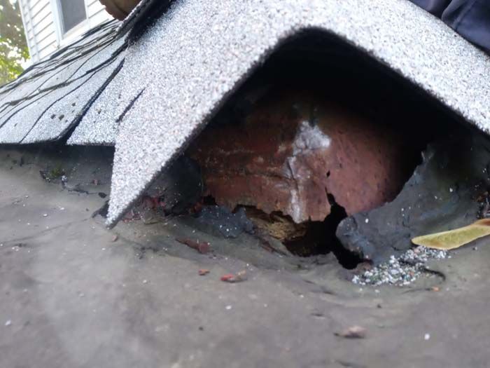 A close up of a roof with a hole in it.