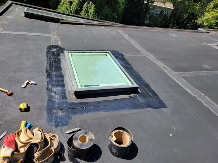 A skylight is being installed on the roof of a building.