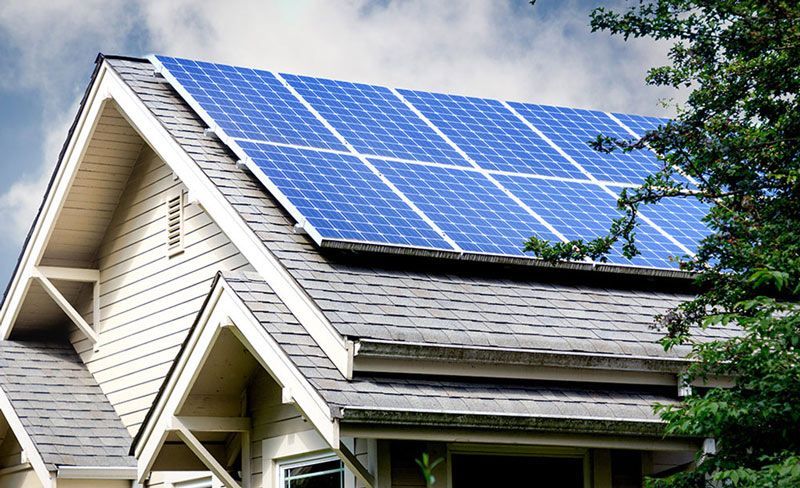 A house with a lot of solar panels on the roof