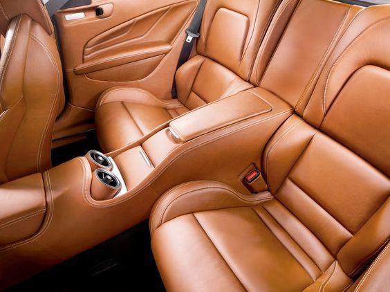 The back seat of a car with brown leather seats
