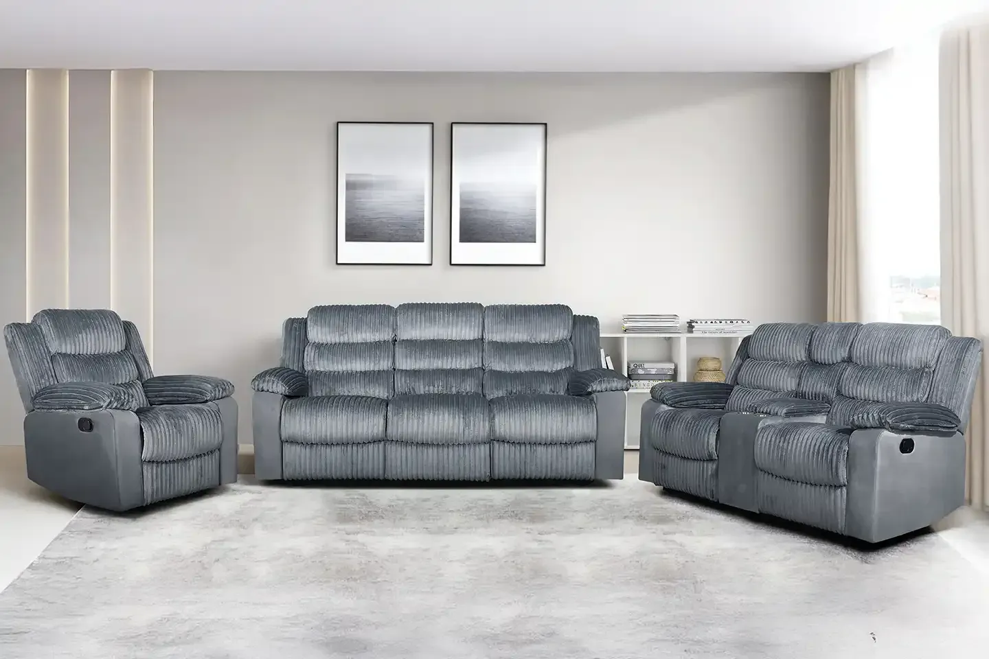 Gray reclining sofa set in a bright modern living room with two framed wall prints