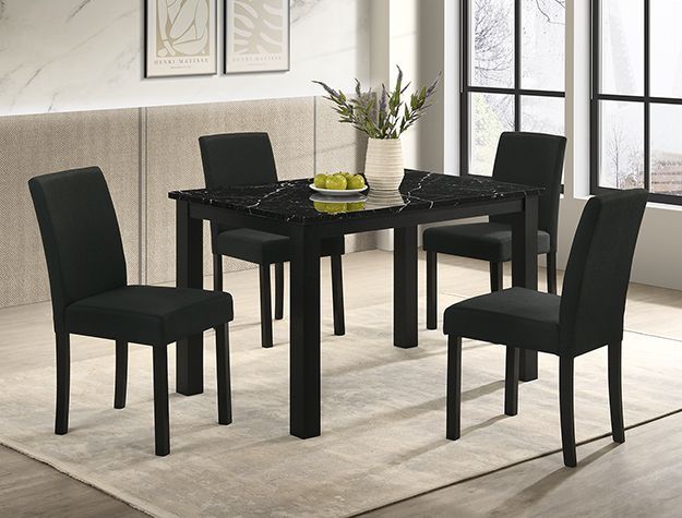 Black dining table with four matching chairs in a bright, modern room