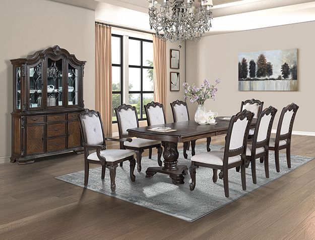Elegant dining room with dark wood table, upholstered chairs, china cabinet, chandelier, and rug