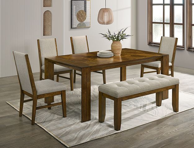 Wooden dining table with six chairs and a tufted bench on a light rug in a bright room