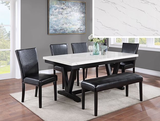 Modern dining room with black chairs, a white table, bench, rug, and abstract wall art.
