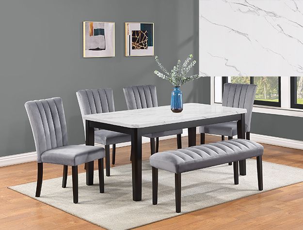 Modern dining room set with gray chairs, dark table, blue vase, and rug by a window