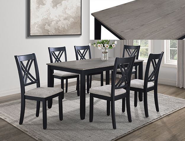 Black dining table set with six chairs on a light rug in a bright room