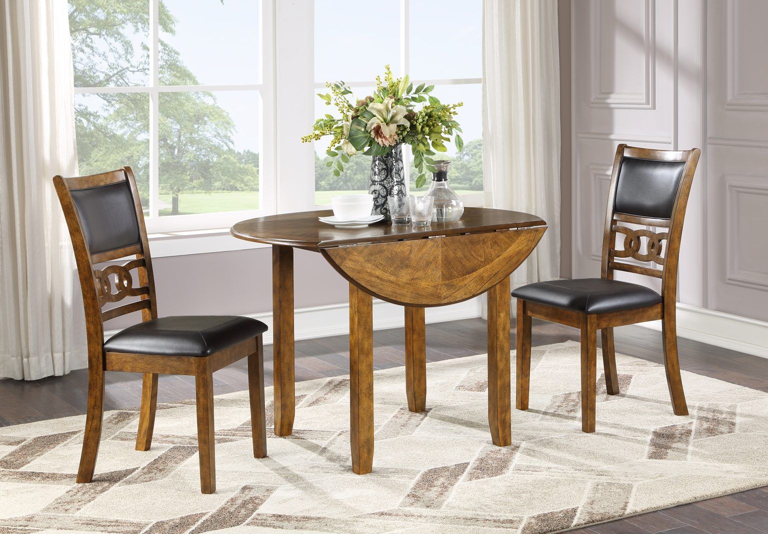 Wooden dining table with two chairs and a flower centerpiece in a bright room