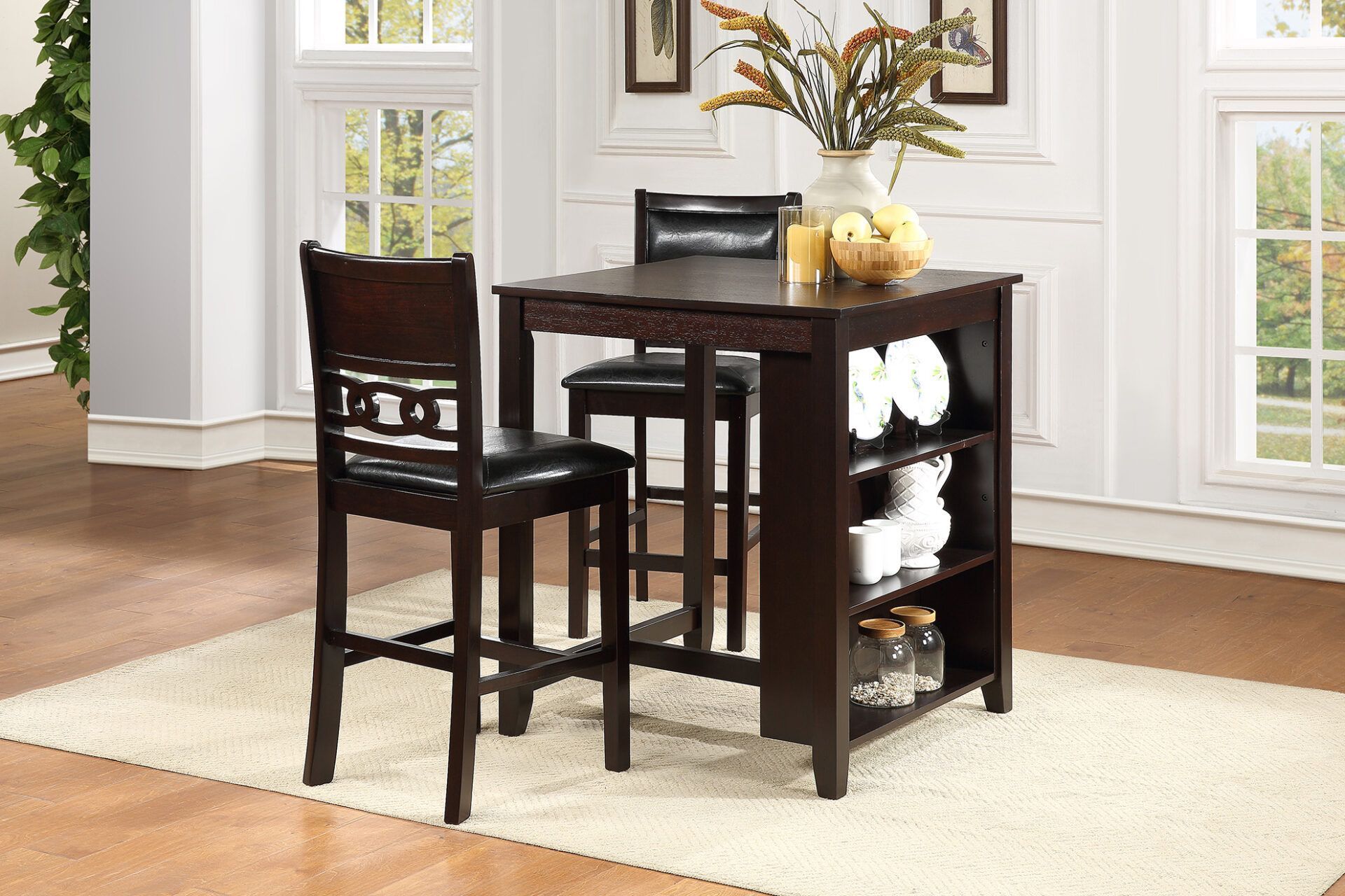 Dark wood kitchen island cart with stool in a bright room with cream rug and windows