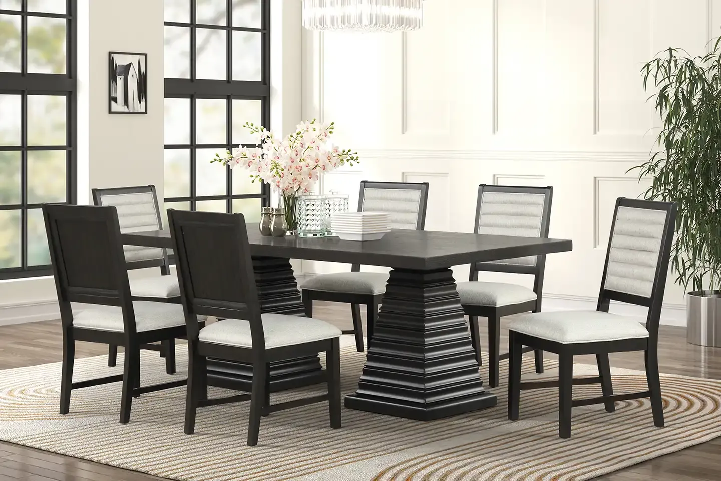 Modern dining room with a black table, six chairs, white flowers, and a woven rug